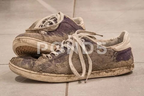 Dirty shoes with mud and soil Stock Photos