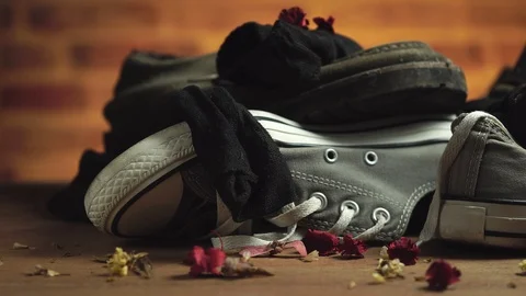 Dirty sneaker and socks stacked on the floor. Stock Footage 125504033