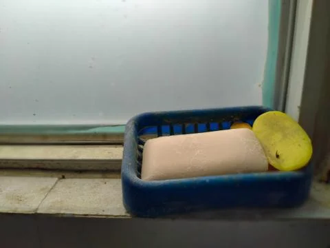 Dirty soap in the window frame. 库存照片