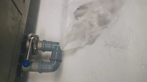Dirty soapy water flows out of the pipe at the factory, chemical pollution Stock Footage 214409717
