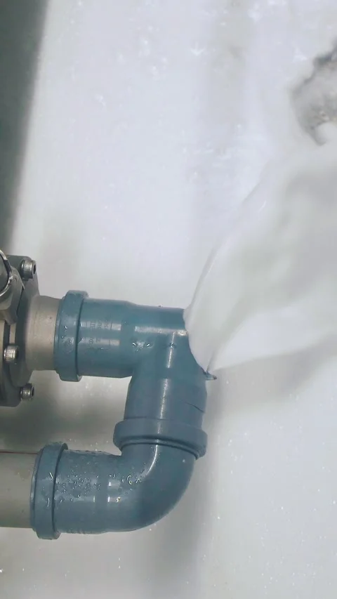 Dirty soapy water flows out of the pipe at the factory, chemical pollution Stock Footage 316891712