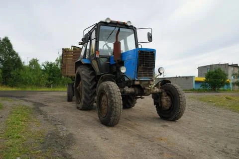 Dirty tractor with the trailer Stock Photos