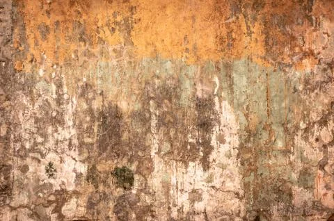 Dirty wall with broken cement plaster. Vintage surface texture. Background for Stock Photos