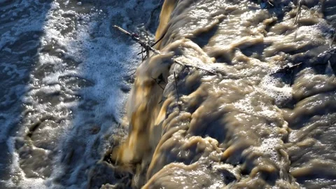 Dirty waste is drained into a stormy river. Stock Footage 88290071