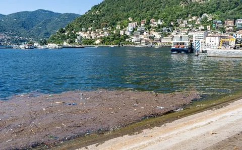 Dirty water and trash float on the surface of Italys Lake Como. Garbage 스톡 사진
