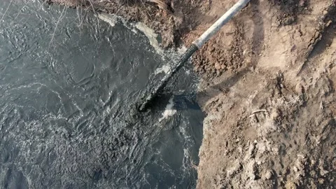 Dirty water flows from the pipe. Aquatic pollution. Ecological catastrophe. The Video stock 172210661