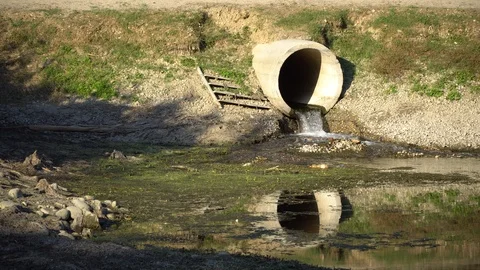 Dirty water flows from a pipe Stock Footage 95601876