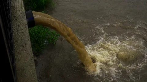 Dirty water flows from the pipe into the... | Stock Video | Pond5