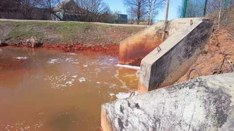 Dirty water flows from pipe sewer and sewerage toxic waste ecology concept Stock Footage 243121693