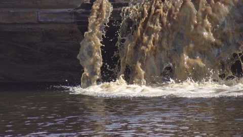 Dirty water flows into the river. Ecological disaster, harm to the environment Video stock 307207564