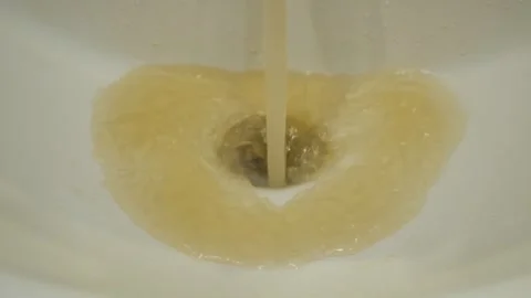 Dirty water flows from the tap into the sink. Contamination of tap water. Stock Footage 317932032