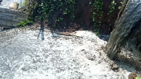 Dirty water flows through the gutters and spills onto the street Stock Footage 232741576