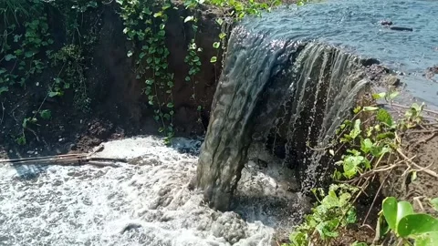 Dirty water flows through the gutters and spills onto the street Stock Footage 232741577