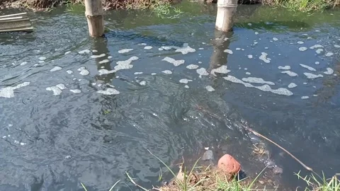 Dirty water flows through the gutters and spills onto the street Stock Footage 232741599