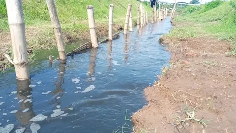 Dirty water flows through the gutters and spills onto the street Stock Footage 232741611