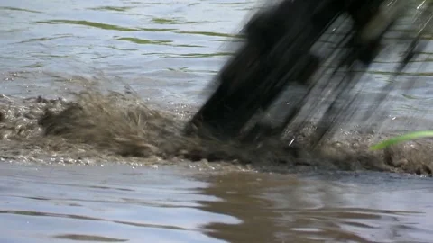 Dirty water from the pipe flows into the river Stock Footage 92551713