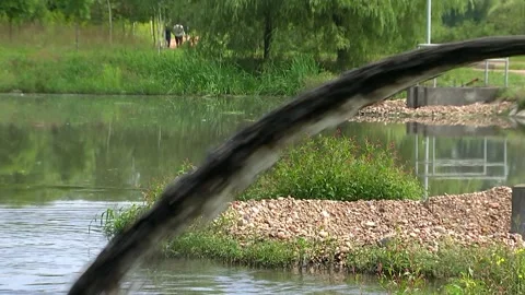 Dirty water from the pipe flows into the river,pollutes the environment Stock Footage 92551878