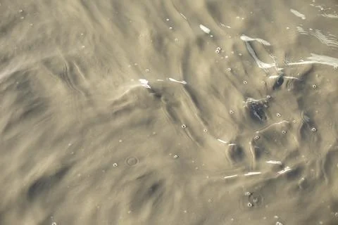 Dirty water. Puddle texture. Waves on surface. Stock Photos