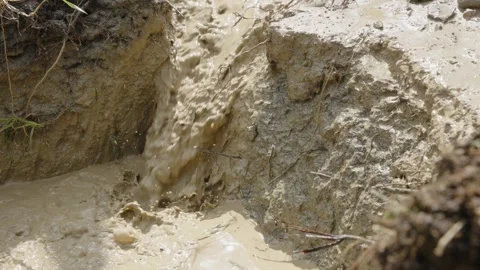Dirty water runs into a puddle while dri... | Stock Video | Pond5