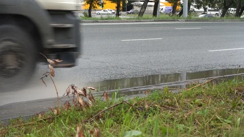 Dirty wave of spray from under the wheels of a truck. Stock Footage 128019526