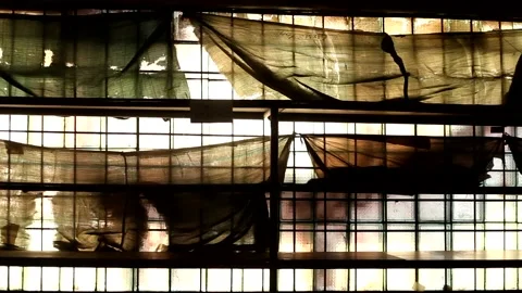 Dirty window of an abandoned building covered with torn old cloth. Stock Footage 167679262