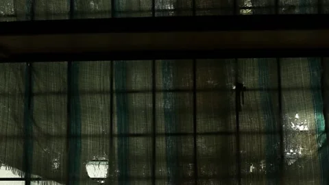 Dirty window of an abandoned building hung with torn cloth. Stock Footage 169182738