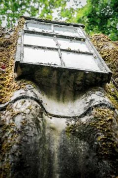 A Dirty Window In A Rusty Frame On A Moss Covered Corrugated Iron Roof Stock Photos
