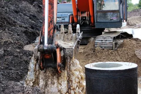 The dirty work of the excavator bucket, which digs and leveled the ground Stock Photos