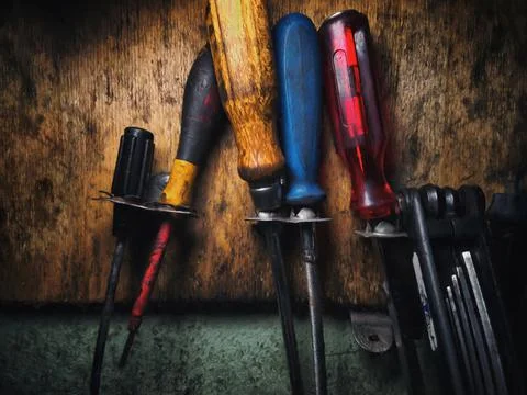 Dirty working tools on the wall in the workshop. Illustration Stock Photos