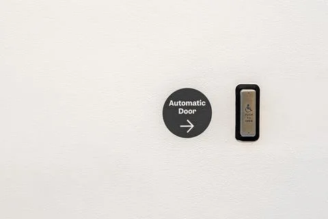 Disability access button to automatically open doors for disabled people. Stock Photos