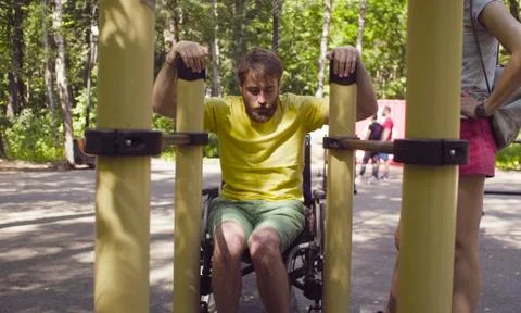 Disable man getting up holding the parallel bars Stock Photos