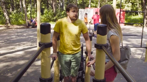 Disable man holding the parallel bars standing on his legs Video stock 93812192