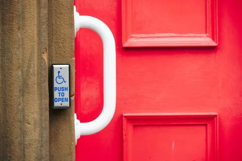 Disabled accessible push button buzzer for assistance sign at building entrance Stock Photos