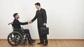 The disabled and a businessman handshake on the white wall background 4k or 4k+ Resolution