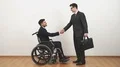 The disabled and a businessman handshake on the white wall background 4k or 4k+ Resolution