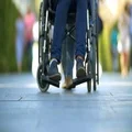 The disabled and woman on the stroll outdoor. Slow motion. Super telephoto lens 4k or 4k+ Resolution