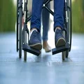The disabled and woman on the stroll outdoor. Slow motion. Super telephoto lens 4k or 4k+ Resolution