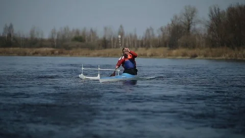 Disabled athlete rowing on the river in a canoe. Rowing, canoeing, paddling Видео 112238814