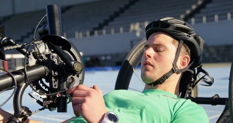 Disabled athlete using smartwatch on a running track 4k 動画素材 96094527
