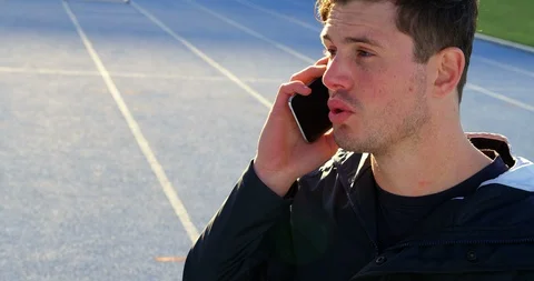 Disabled athletic talking on mobile phone 4k Video stock 96094502