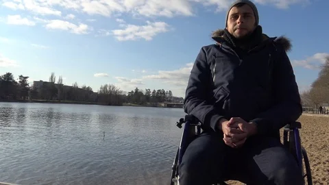 Disabled Boy Looks Out Over a Lake Stock Footage 123365254