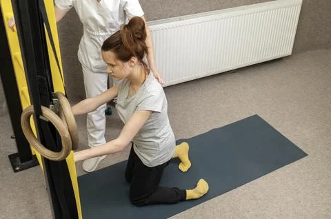 Disabled Child With Physician Does Physical Exercises In Gym. Kid With Special Stock Photos