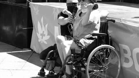 Disabled crying on a march, procession for the legalization of medical drugs. Stock Footage 133889532