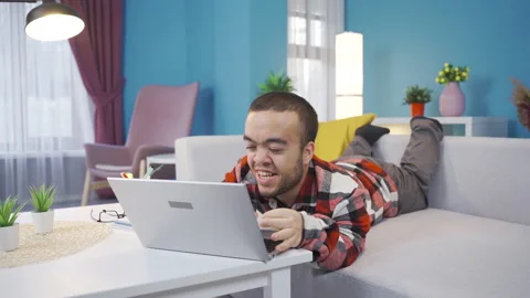 Disabled dwarf young man happy and cheerful using laptop Stock Footage 230975737