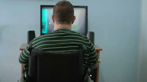 Disabled guy watching movie on computer at home during lockdown,medical tech Video stock 153385151
