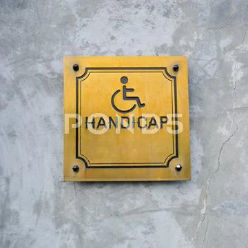 Disabled Handicap Icon and wording Handicap Sign made from gold metal board Stock Photos