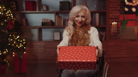Disabled Lady Holding Gift Box, Wishing Happy New Year and Christmas Celebration Stock Footage 253500522