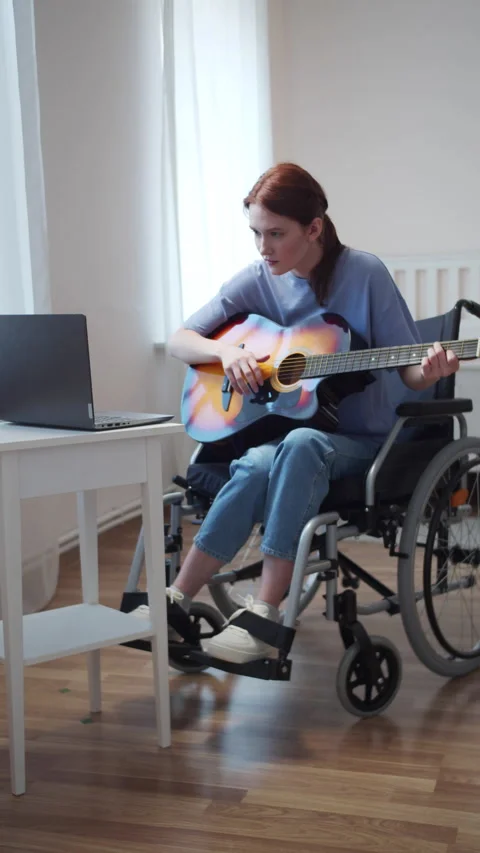A disabled lady is learning to play the guitar Stock Footage 163063930