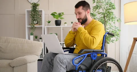 Disabled man celebrating success while working on laptop Video stock 145207939