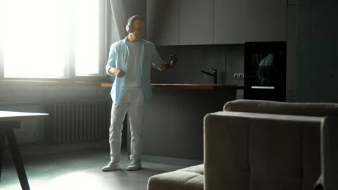 Disabled man with high tech hand prothesis listens to music Stock Footage 157534787